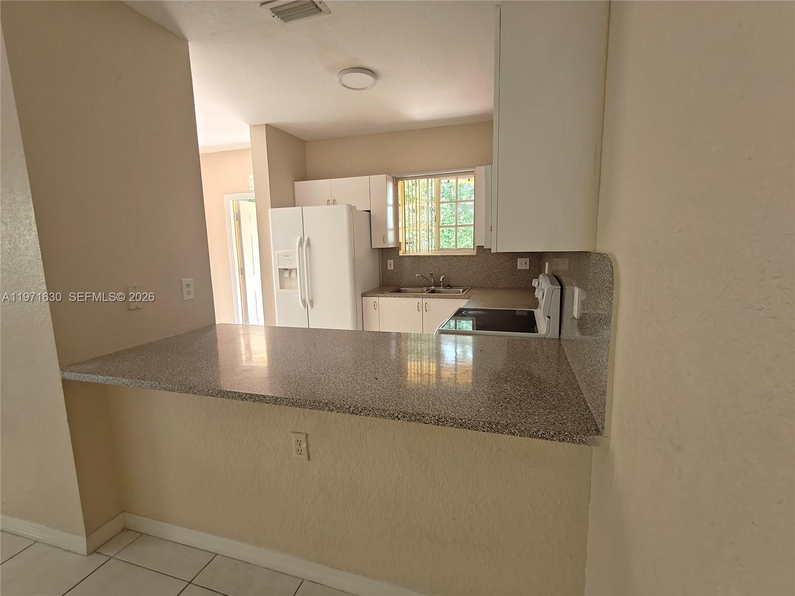 6756 Northwest 182nd Street, Unit 101 Hialeah, FL 33015 - Photo 6 of 29 view of a kitchen with a sink and dishwasher
