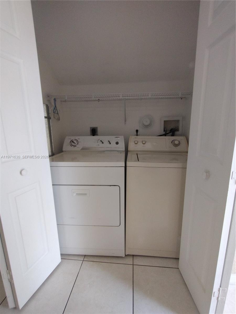 6756 Northwest 182nd Street, Unit 101 Hialeah, FL 33015 - Photo 9 of 29 a utility room with dryer and washer