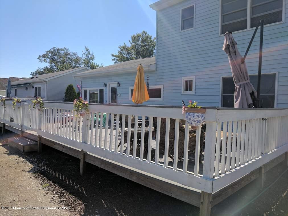 806 Harbor Road Forked River, NJ 08731 - Photo 8 of 12 a view of a wooden house with a small yard