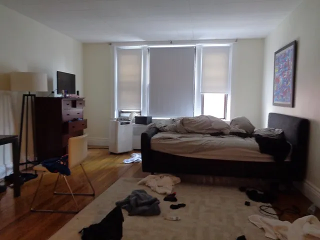 a bedroom with a bed and a window