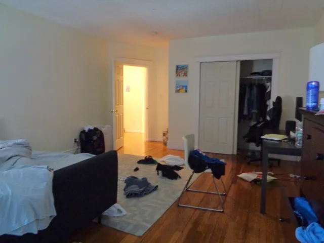 a bed room with a bed and a window