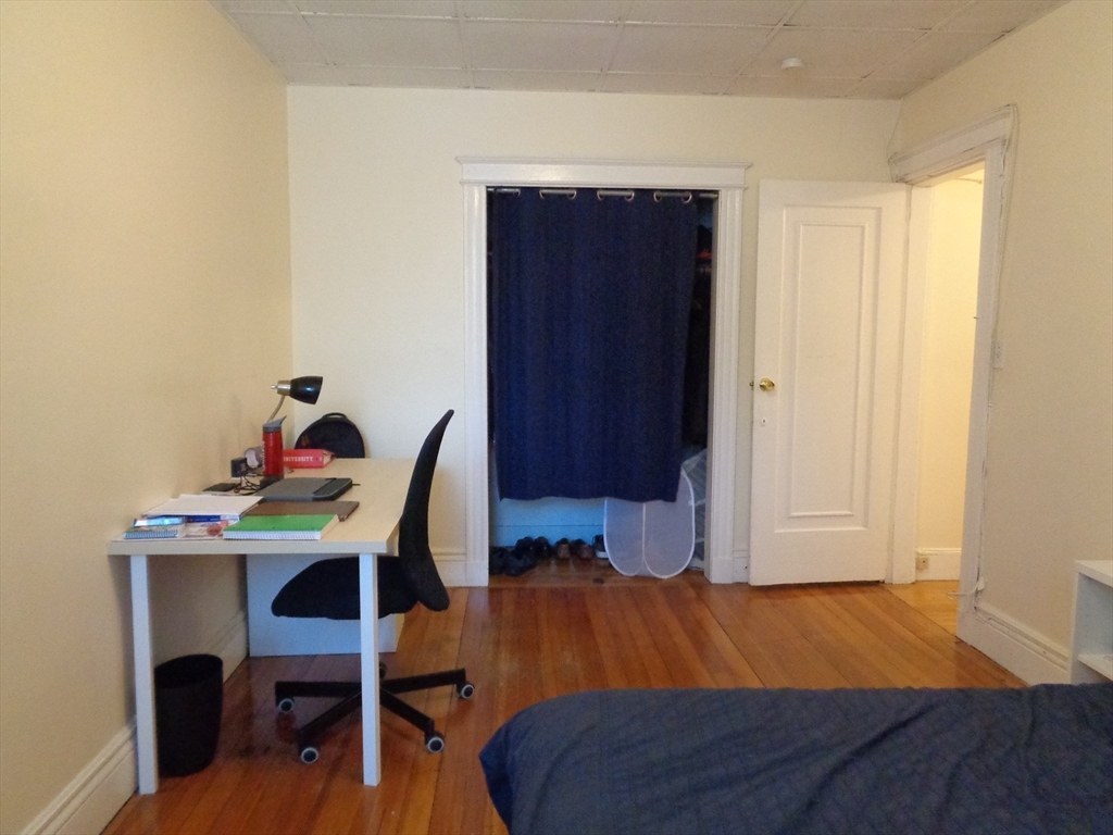 40 Carlton Street, Unit 10 Brookline, MA 02446 - Photo 9 of 11 a bedroom with a bed and a table in it