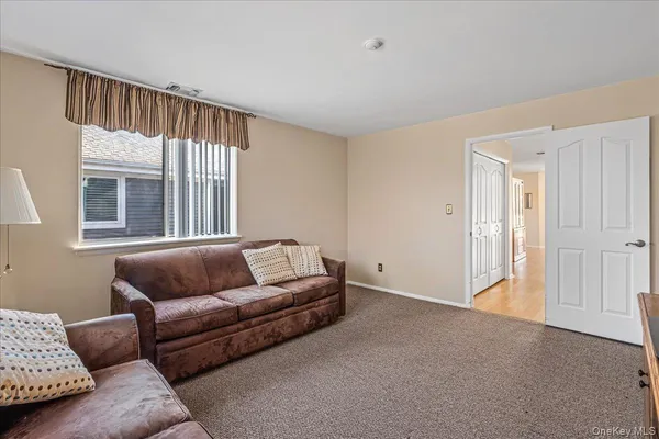 a living room with a couch and a window