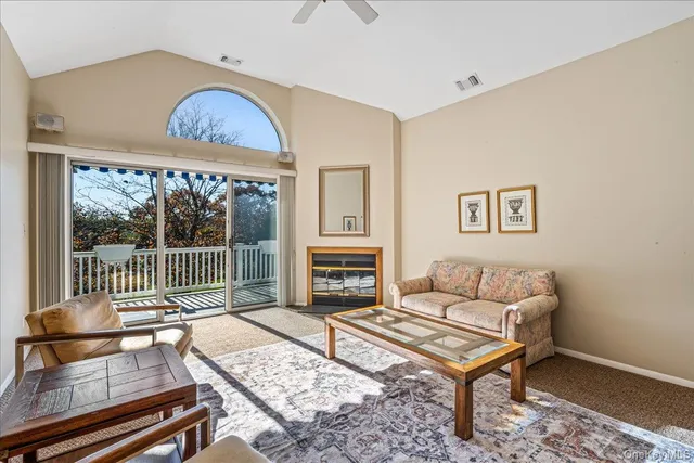 a living room with furniture a fireplace and a table