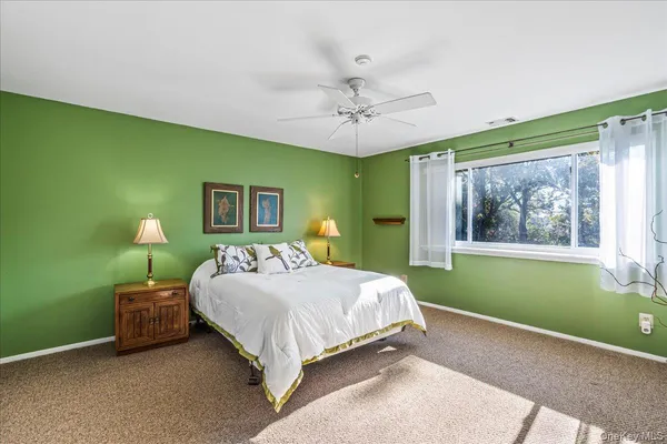 a bedroom with a bed table and chair