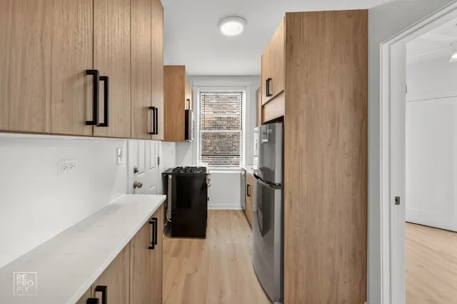 a kitchen with a refrigerator and a sink