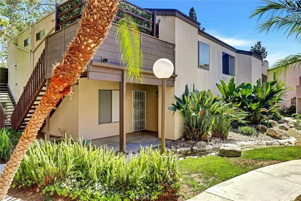 a front view of house with a garden