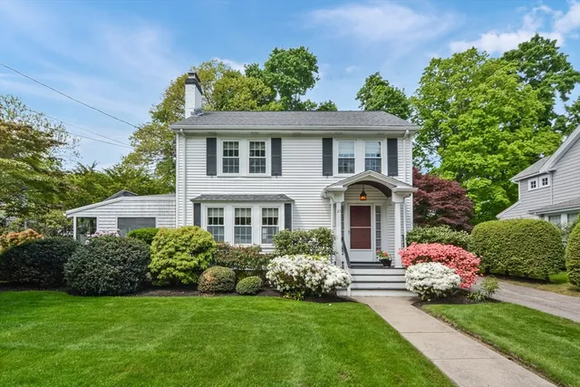 a front view of a house with a garden