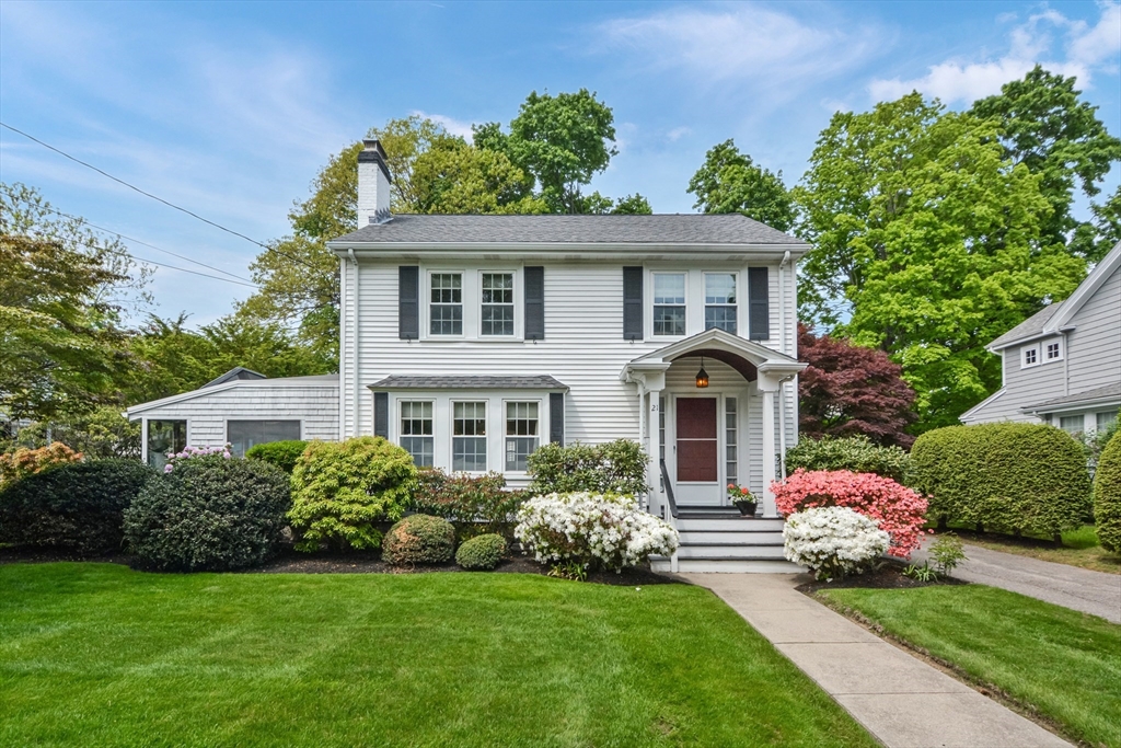 a front view of a house with a garden
