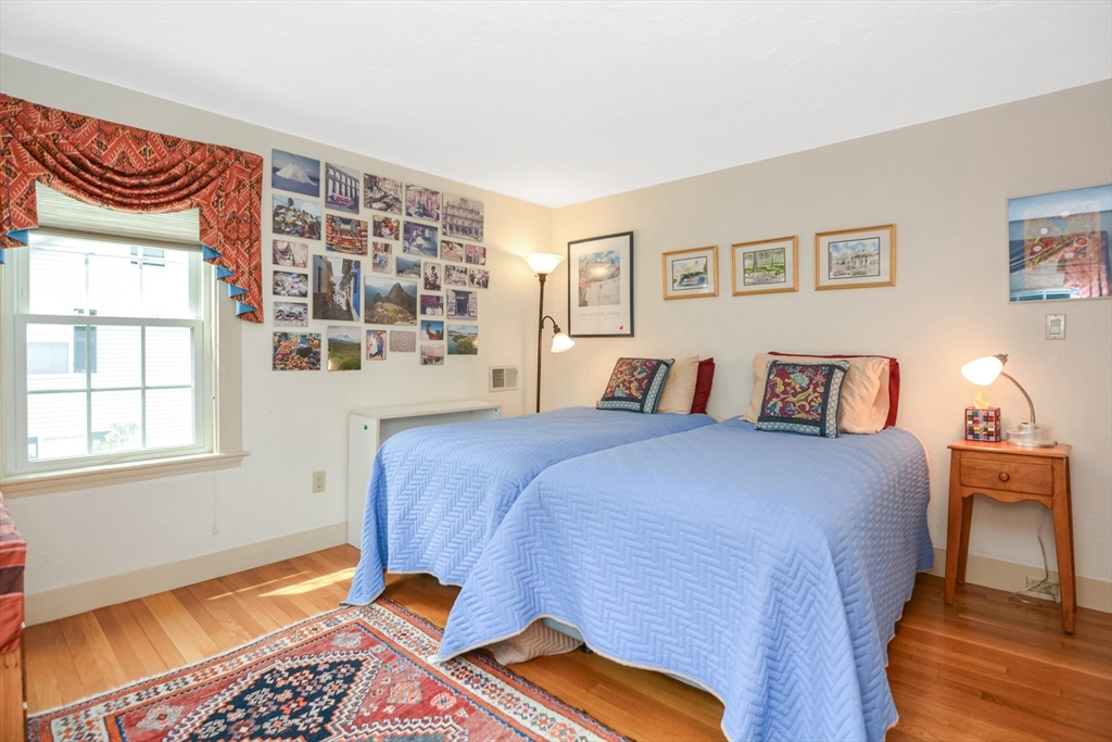 21 Stevens Road Needham, MA 02492 - Photo 16 of 26 a bedroom with a bed and a lamp next to a window