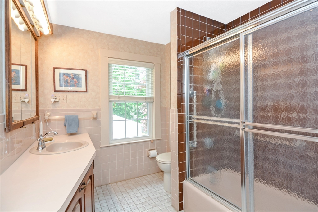 21 Stevens Road Needham, MA 02492 - Photo 18 of 26 a bathroom with a granite countertop sink a toilet and shower