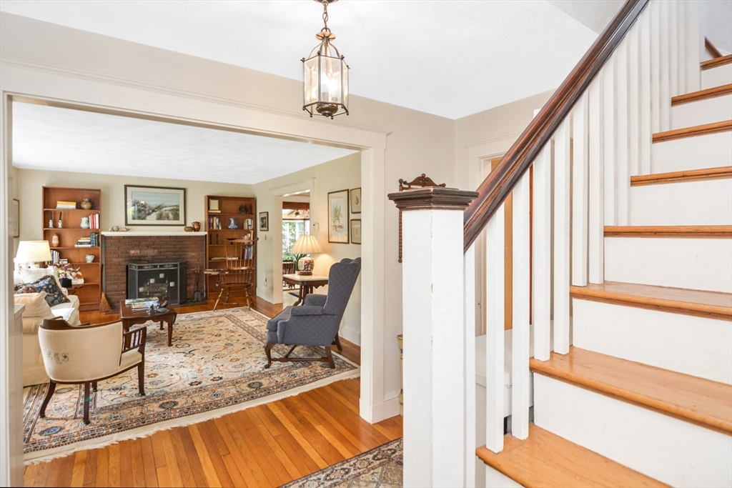 21 Stevens Road Needham, MA 02492 - Photo 19 of 26 a view of a livingroom with furniture a fireplace a window and wooden floor