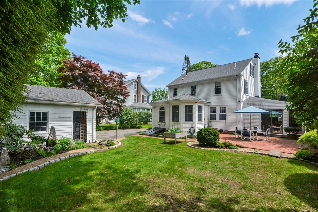 21 Stevens Road Needham, MA 02492 - Photo 20 of 26 a front view of a house with garden and trees