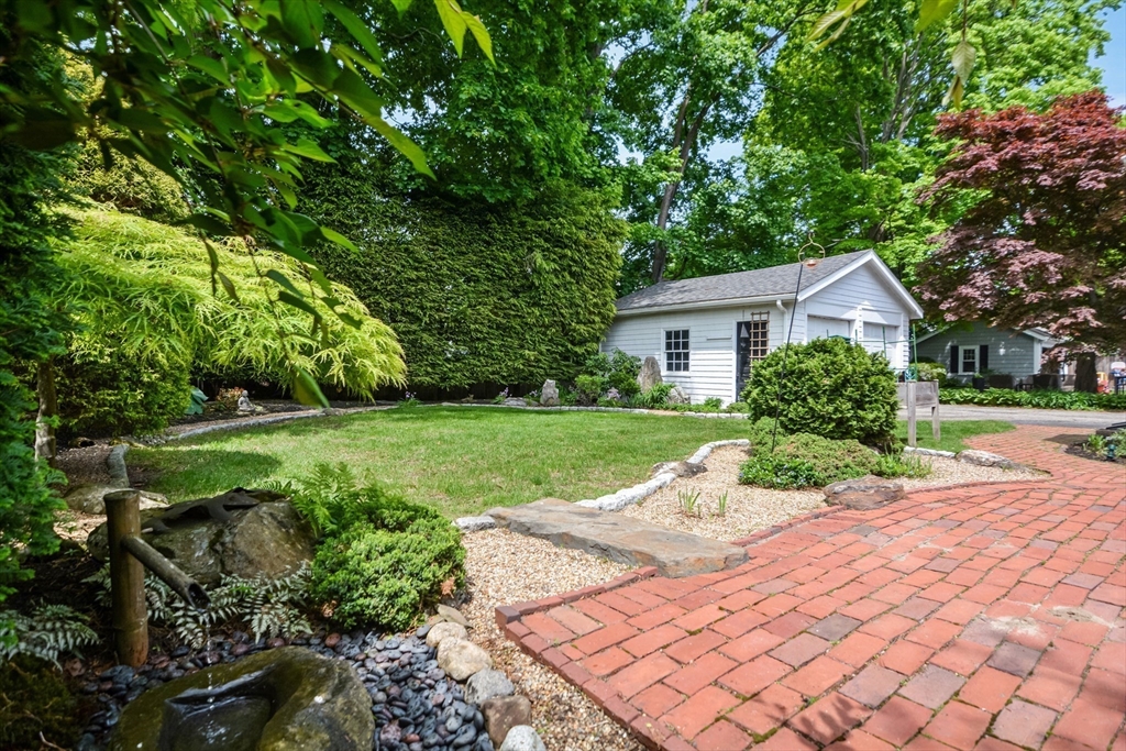 21 Stevens Road Needham, MA 02492 - Photo 21 of 26 a view of a house with yard and a garden