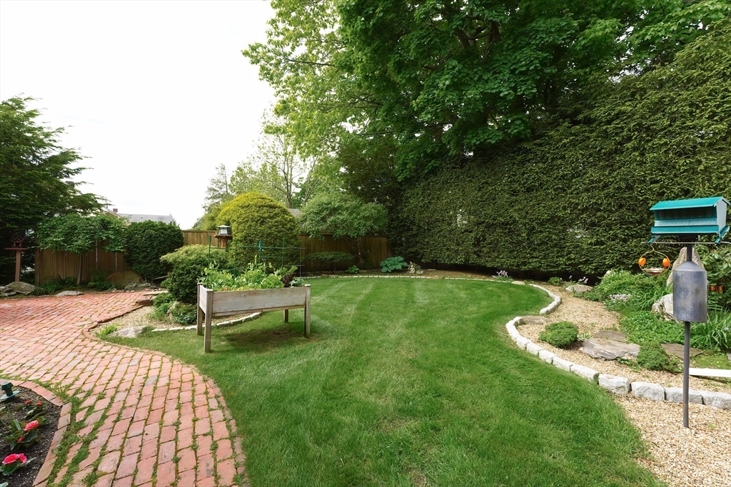 21 Stevens Road Needham, MA 02492 - Photo 25 of 26 a view of a chair and table on the garden