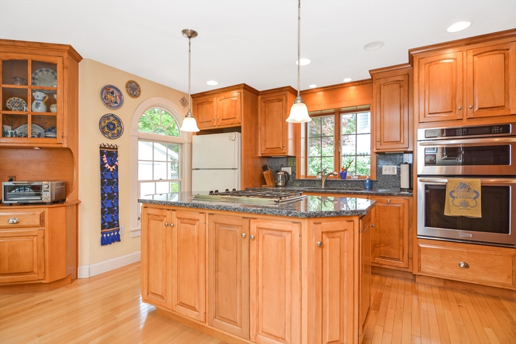 21 Stevens Road Needham, MA 02492 - Photo 4 of 26 a kitchen with stainless steel appliances granite countertop a stove a sink and a refrigerator