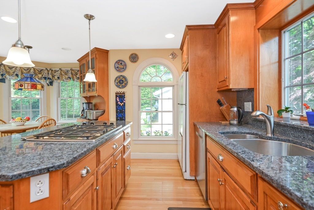 21 Stevens Road Needham, MA 02492 - Photo 6 of 26 a kitchen with granite countertop a sink a counter top space and stainless steel appliances
