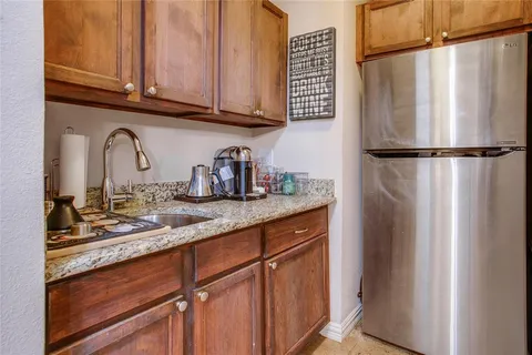 a kitchen with stainless steel appliances granite countertop a refrigerator and a sink