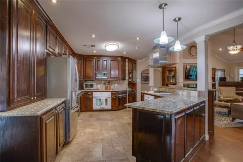 a kitchen with stainless steel appliances granite countertop counter space a refrigerator and a sink