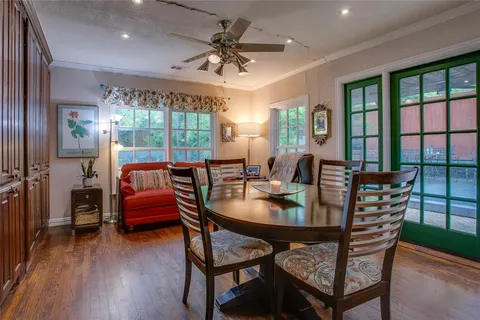 a dining room with furniture a chandelier and wooden floor