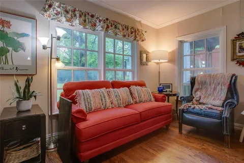a bedroom with furniture and a large window