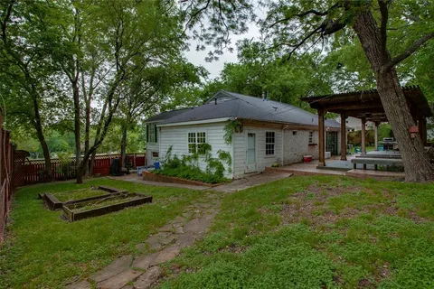 a view of patio with table and chairs with wooden floor and fence