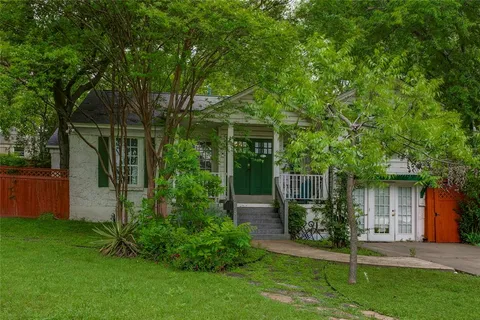 a front view of house with a garden