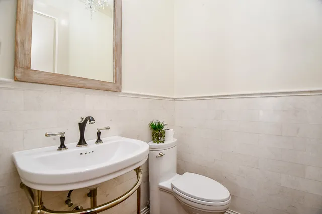 a bathroom with a sink a toilet and mirror