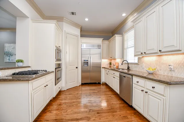 a kitchen with granite countertop a sink and cabinets