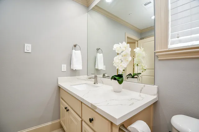 a bathroom with a sink vanity and a mirror