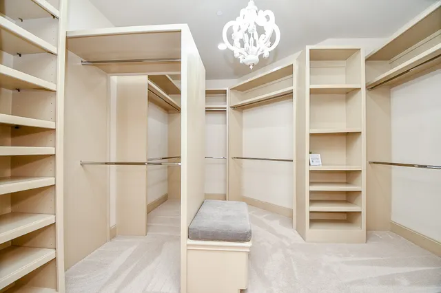 a view of a room with wooden floor and a window