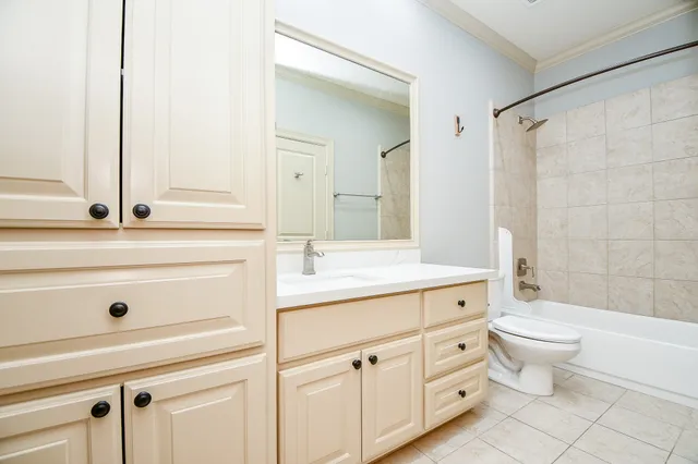 a bathroom with a double vanity sink mirror and toilet