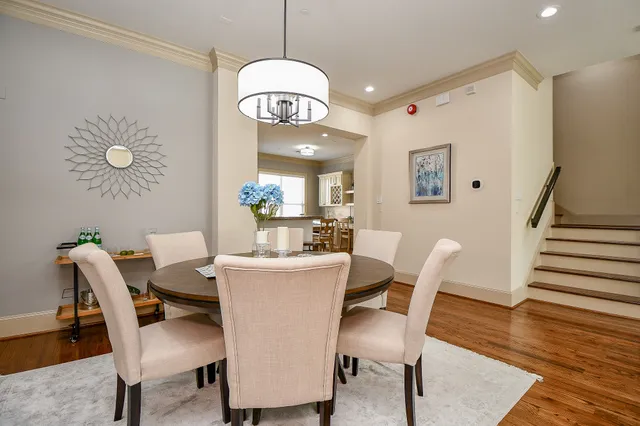 a view of a dining room with furniture wooden floor and a chandelier