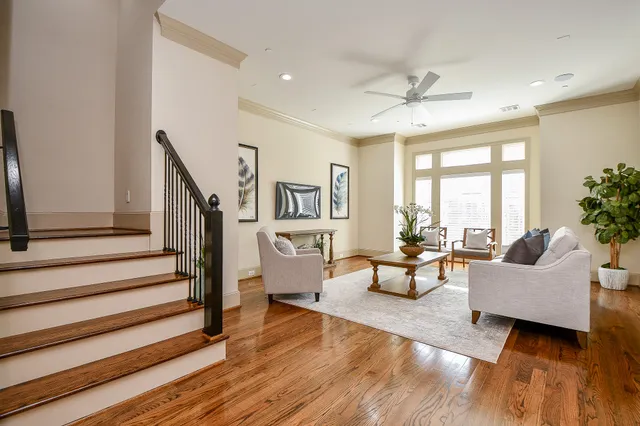 a living room with furniture and wooden floor