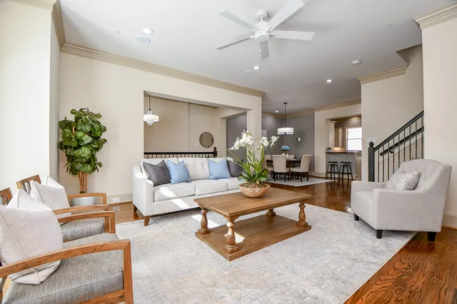 a living room with furniture and a chandelier