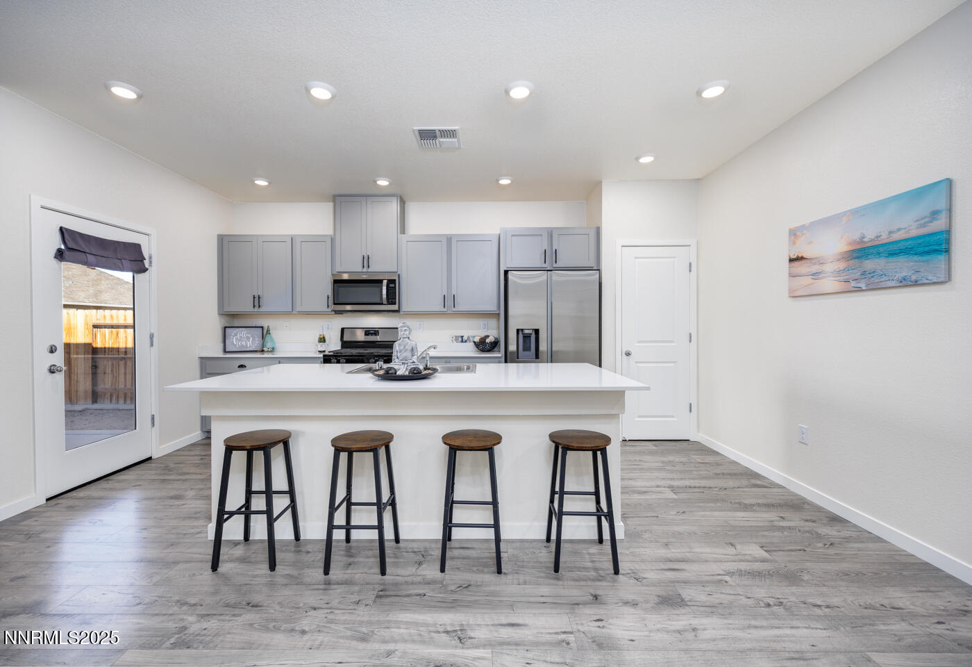 775 Karry Way Fallon, NV 89406 - Photo 6 of 26 a kitchen with stainless steel appliances granite countertop a sink a stove a refrigerator and a microwave