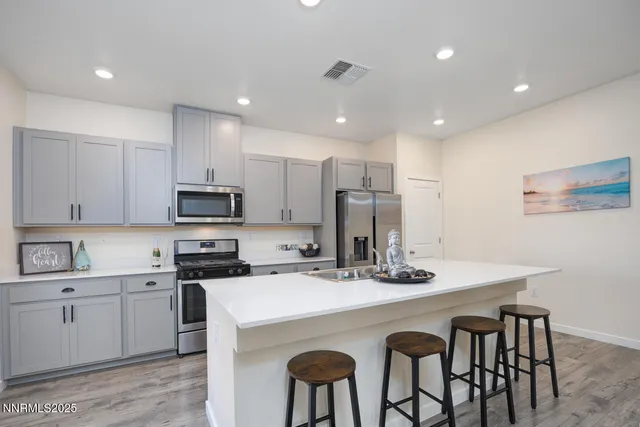 a kitchen that has a table and chairs in it