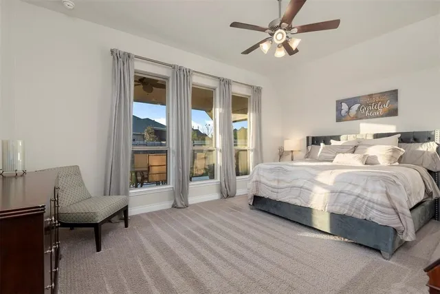 a spacious bedroom with a bed and a table in it