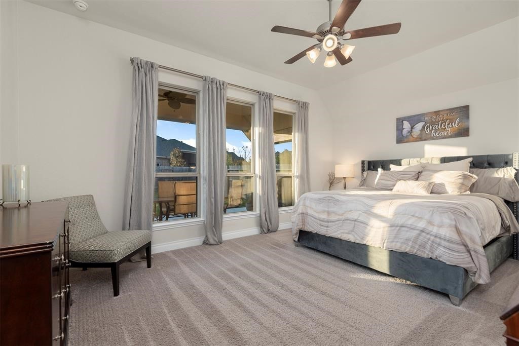 28196 Knight Peak Drive Spring, TX 77386 - Photo 11 of 31 a spacious bedroom with a bed and a table in it