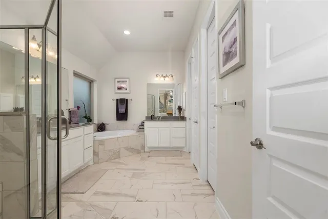 a large white room with a large mirror and shower