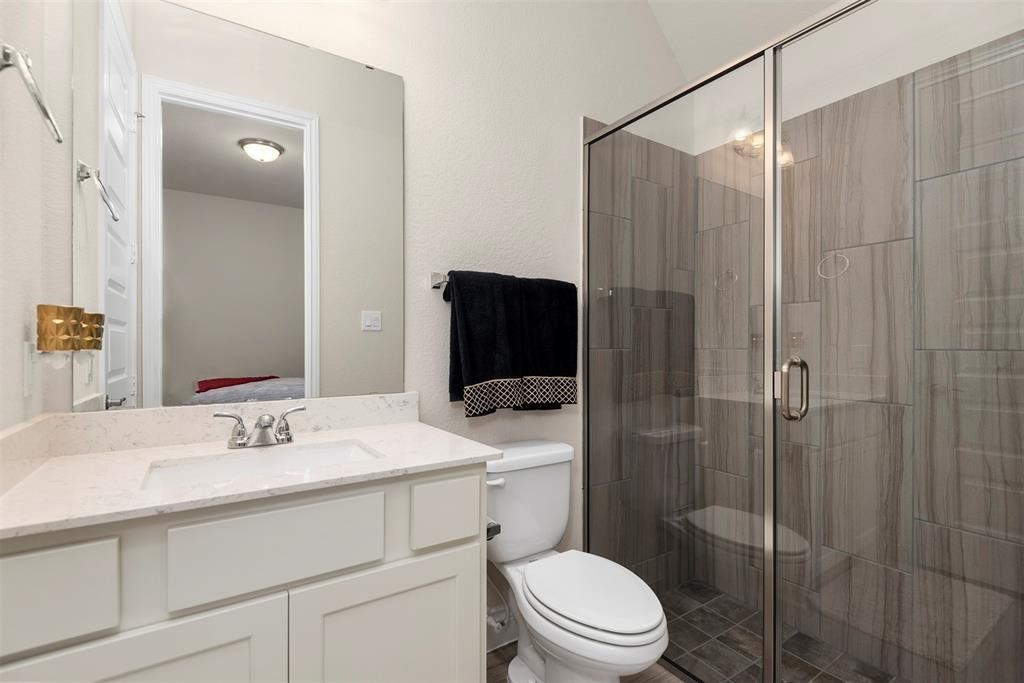 28196 Knight Peak Drive Spring, TX 77386 - Photo 17 of 31 a bathroom with a sink toilet vanity and shower