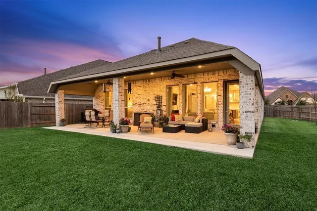 a backyard of a house with table and chairs