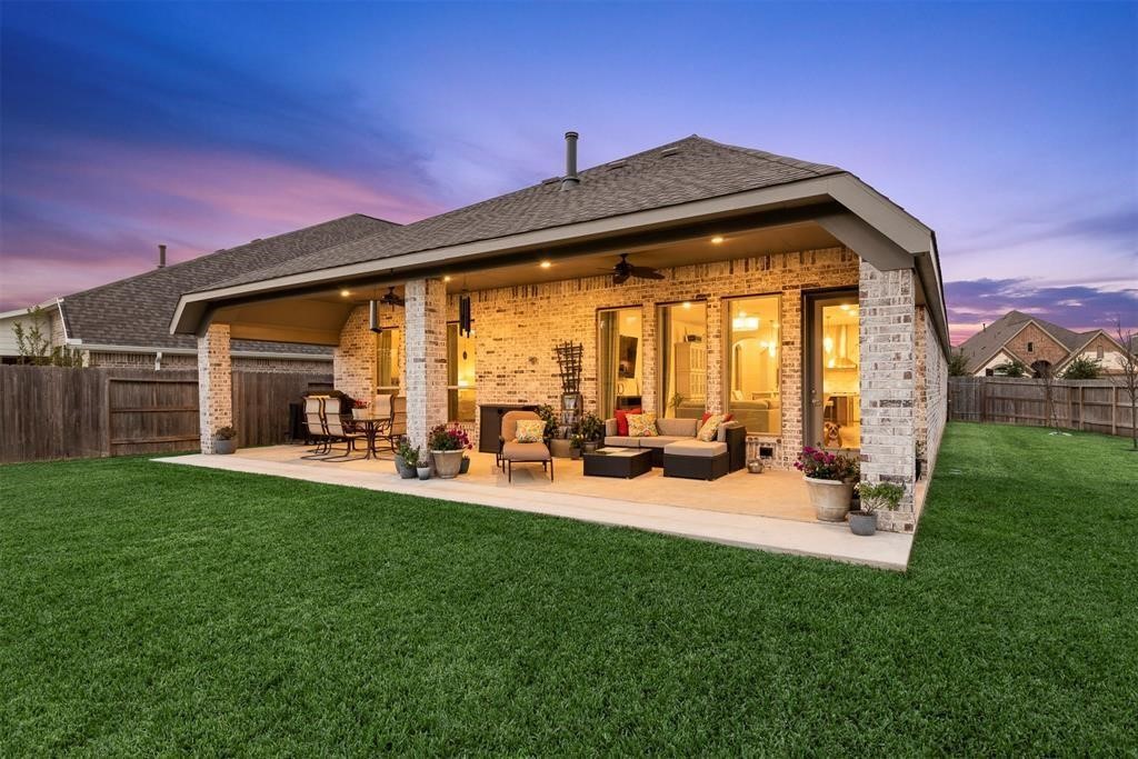 28196 Knight Peak Drive Spring, TX 77386 - Photo 31 of 31 a backyard of a house with table and chairs