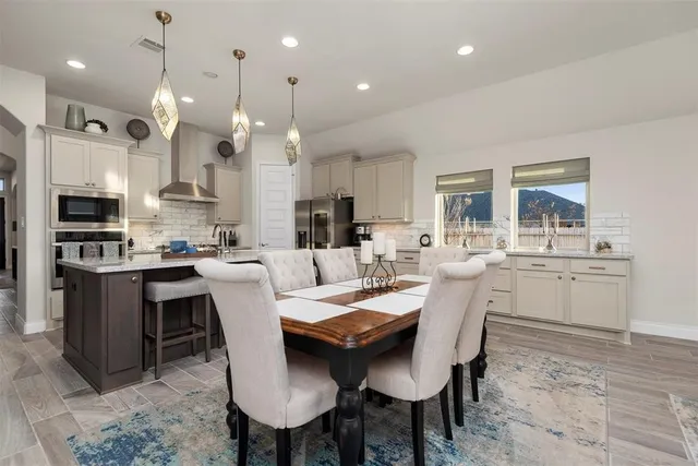 a large kitchen with a table and chairs