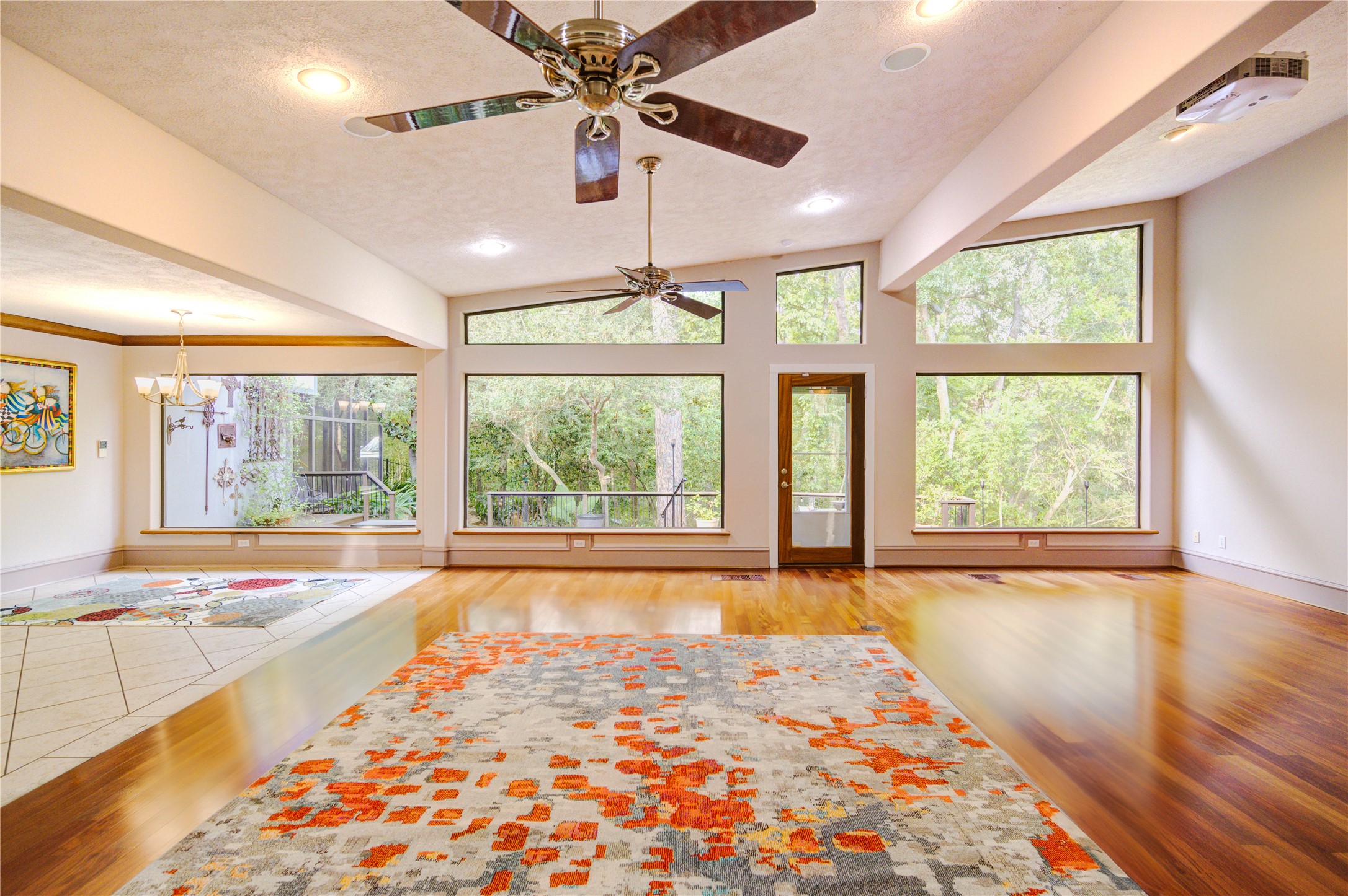 6 Gessner Road Houston, TX 77024 - Photo 13 of 49 a view of an empty room with wooden floor and a window