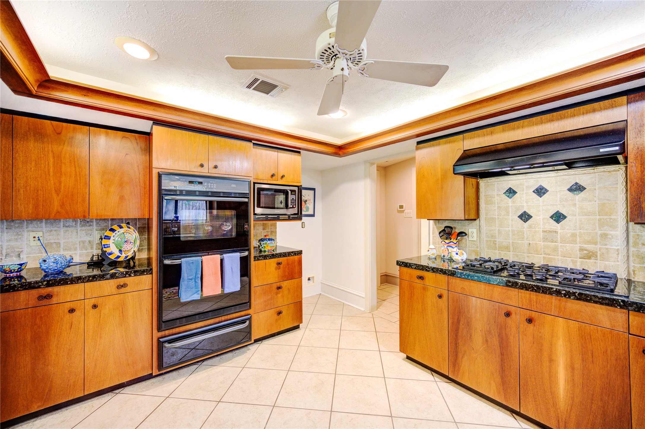6 Gessner Road Houston, TX 77024 - Photo 15 of 49 a kitchen with stainless steel appliances a sink and cabinets