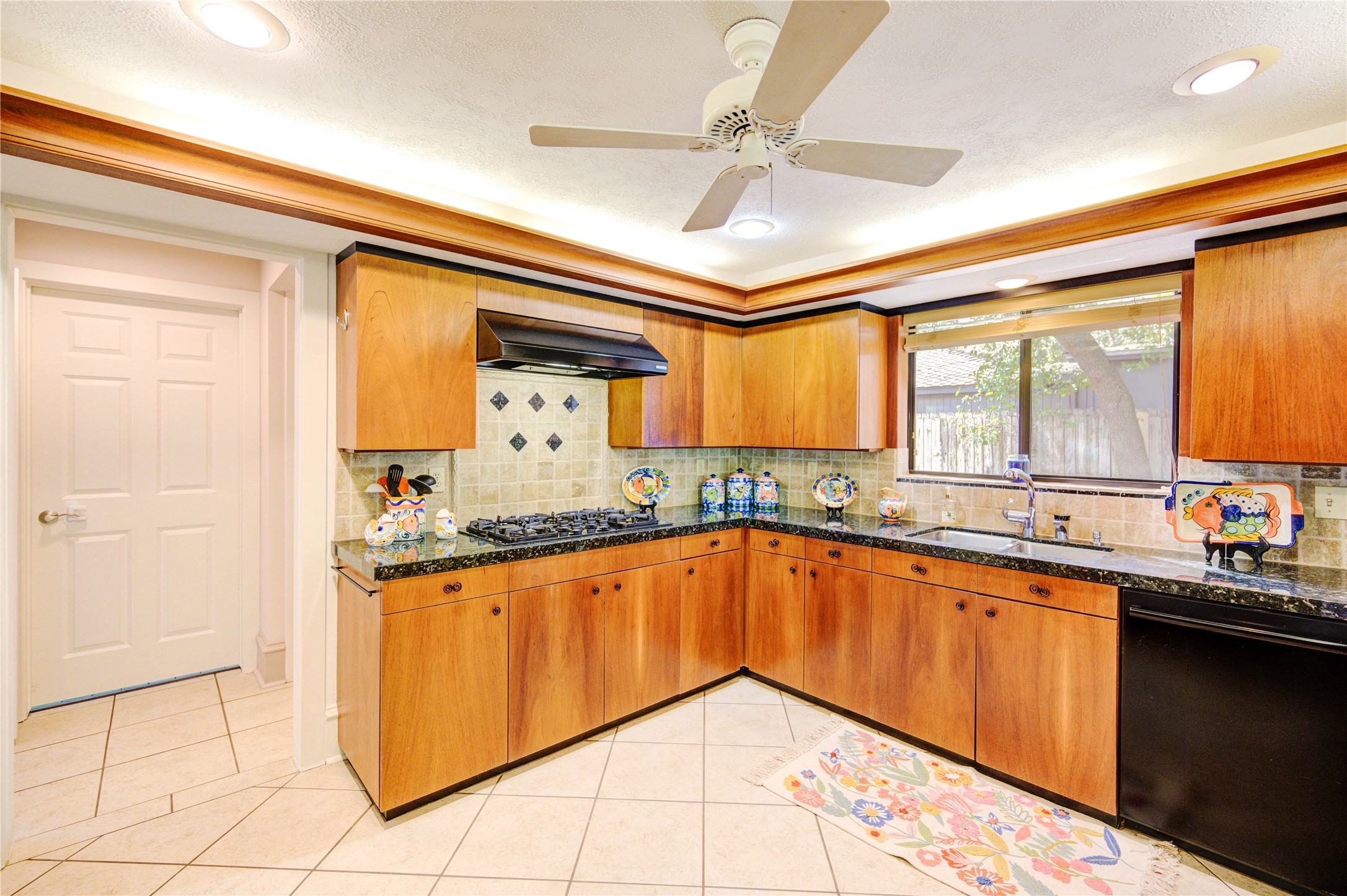 6 Gessner Road Houston, TX 77024 - Photo 16 of 49 a kitchen with granite countertop a sink window and cabinets