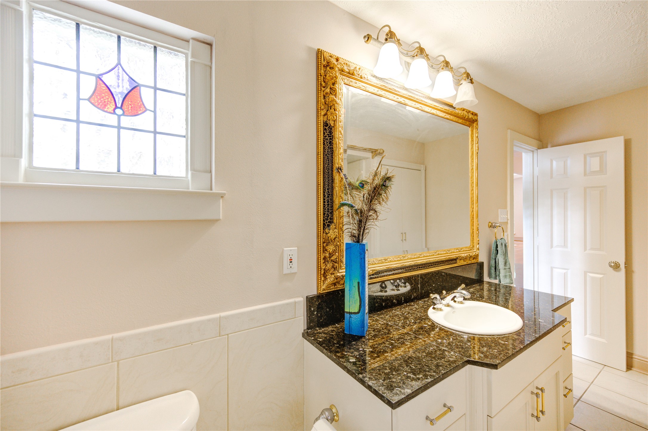 6 Gessner Road Houston, TX 77024 - Photo 22 of 49 a bathroom with a granite countertop sink a mirror and a shower