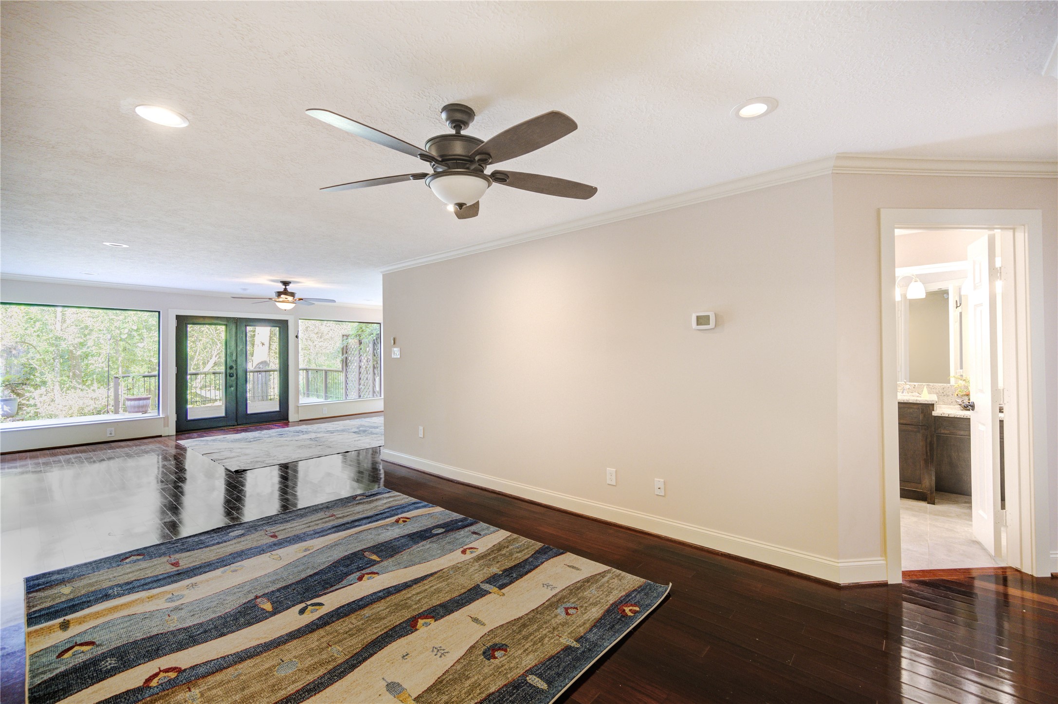 6 Gessner Road Houston, TX 77024 - Photo 24 of 49 a view of a livingroom with wooden floor and a ceiling fan