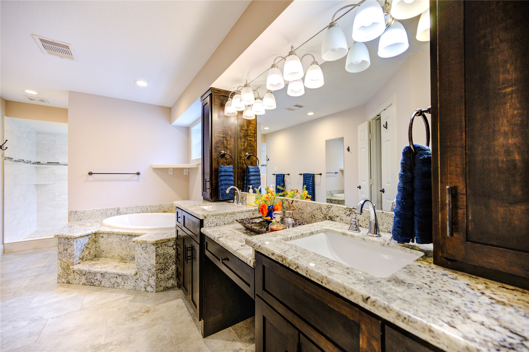 6 Gessner Road Houston, TX 77024 - Photo 27 of 49 a bathroom with a granite countertop sink a large mirror and shower